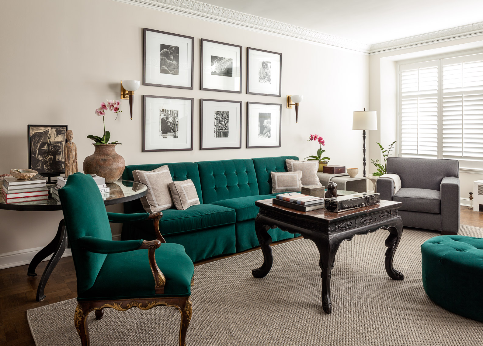 Vintage apartment interior with green velvet upholstery and framed art on wall