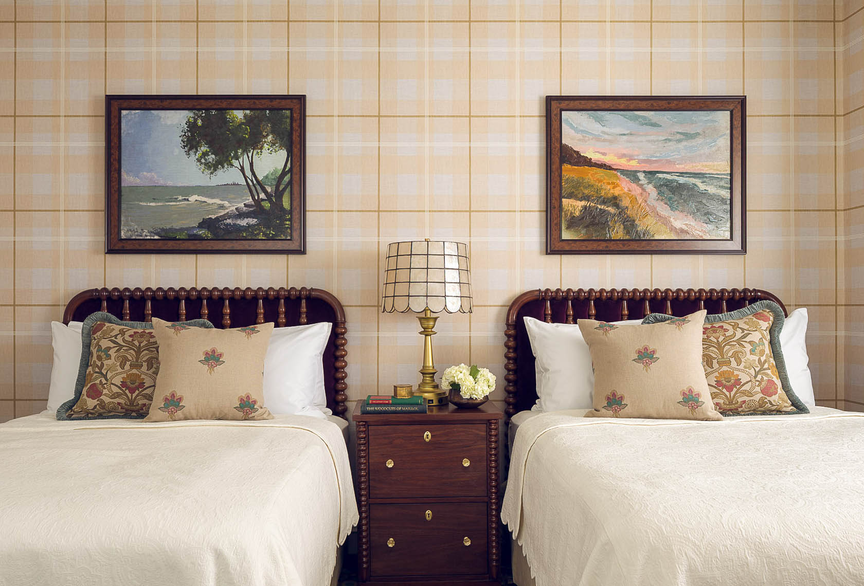 hotel bedroom with wallpaper and framed art over bed